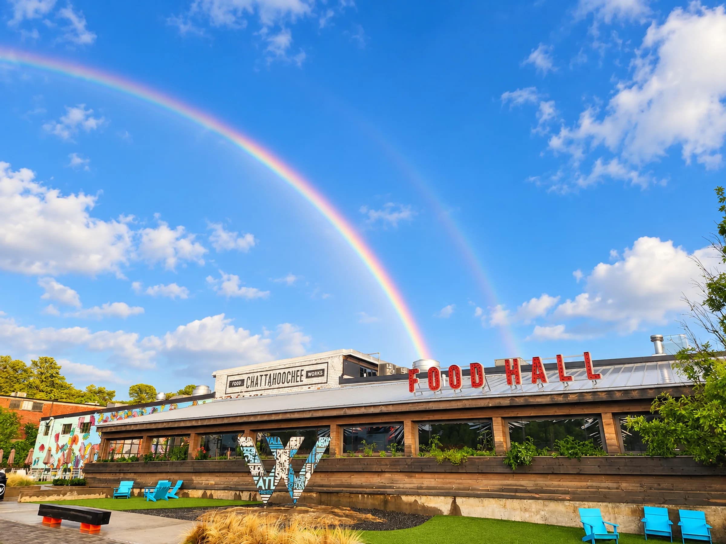 The Food Hall rooftop sign under a rainbow after the rain
