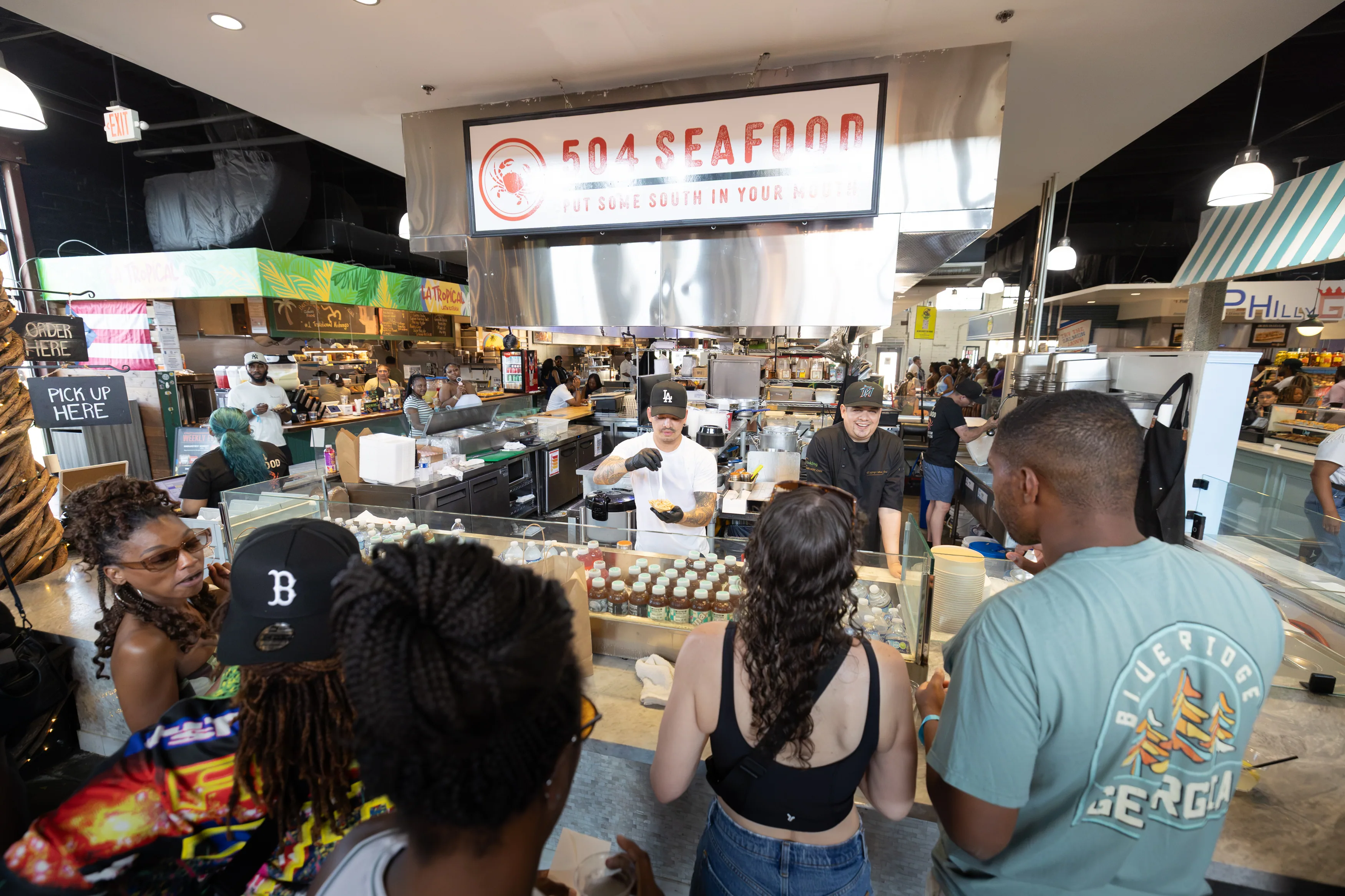 Guests ordering at the 504 Seafood stall inside the food hall