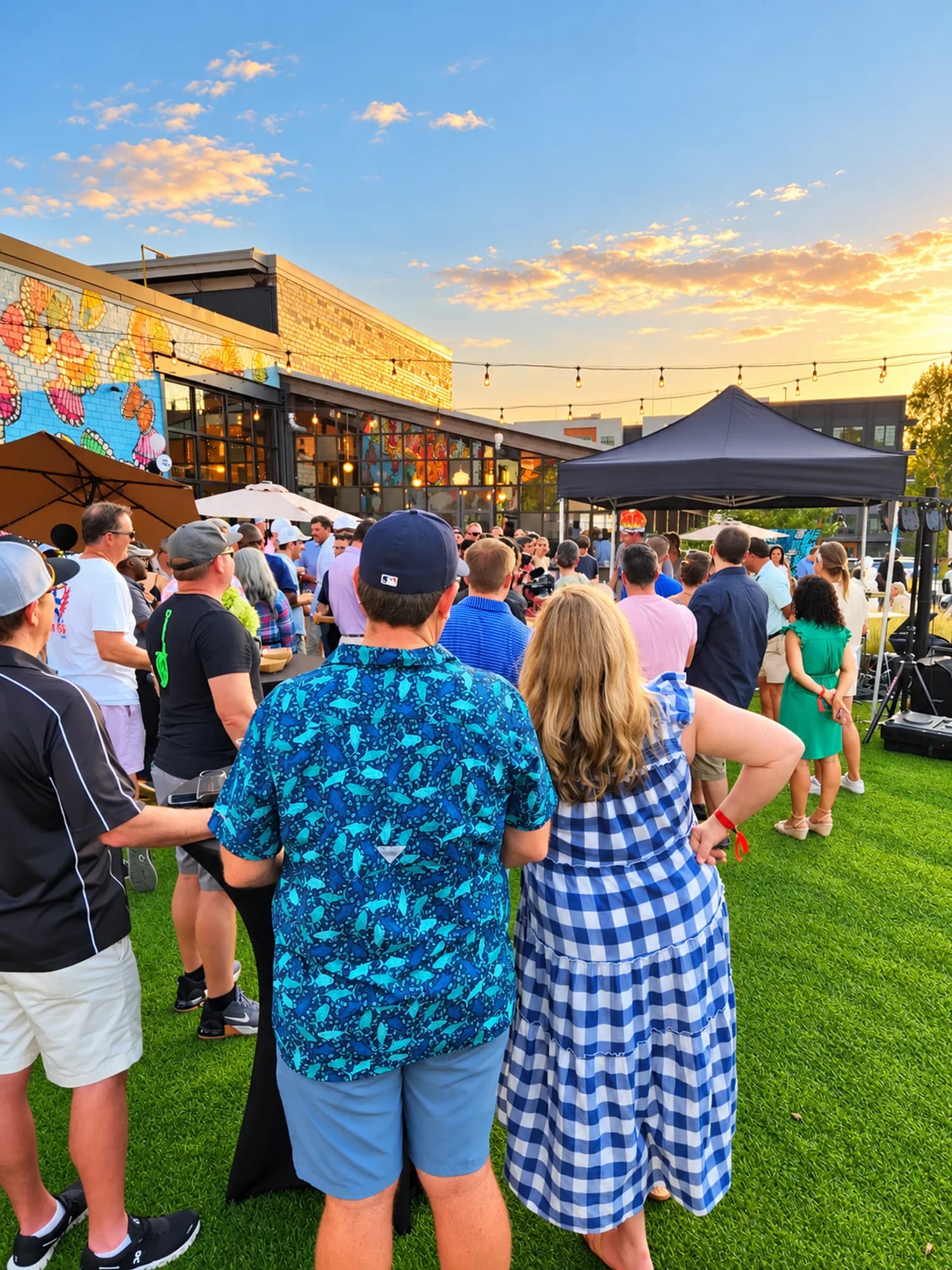 A golden-hour crowd gathered on the outdoor turf
